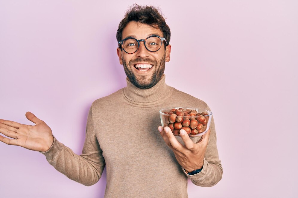 A person eating hazelnuts 